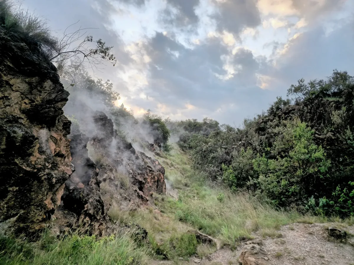 Kenya Safari Destinations 30 Rock cliffs and vegetation beneath a cloudy sky